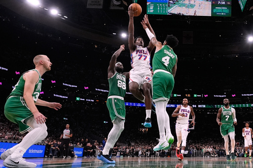 Philadelphia 76ers guard VJ Edgecombe (77) drives to the basket against Boston Celtics guard Anfernee Simons (4) during the second half of an NBA basketball game, Wednesday, Oct. 22, 2025, in Boston. (AP Photo/Charles Krupa)