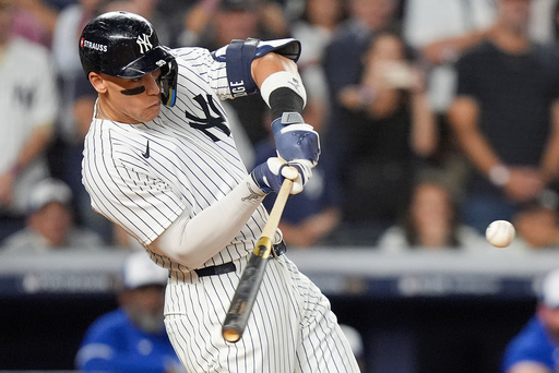 New York Yankees' Aaron Judge connects for a three-run home run against the Toronto Blue Jays during the fourth inning of Game 3 of baseball's American League Division Series, Tuesday, Oct. 7, 2025, in New York. (AP Photo/Frank Franklin II)