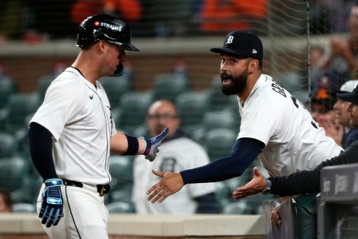 Detroit Tigers' Spencer Torkelson, left, is congratulated by teammate Riley Greene after scoring during the ninth inning in Game 3 of baseball's American League Division Series against the Seattle Mariners Tuesday, Oct. 7, 2025, in Detroit. (AP Photo/Ryan Sun)