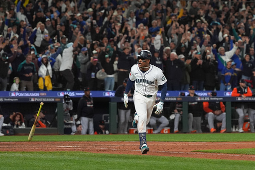 Seattle Mariners' Jorge Polanco reacts after hitting an RBI-single for J.P. Crawford to score the game-winning run during the 15th inning in Game 5 of baseball's American League Division Series against the Detroit Tigers, Friday, Oct. 10, 2025, in Seattle. (AP Photo/Lindsey Wasson)