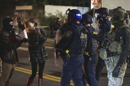 A protester is sprayed by a Department of Homeland Security officer outside a U.S. Immigration and Customs Enforcement facility on Thursday, Oct. 2, 2025, in Portland, Ore. (AP Photo/Jenny Kane)