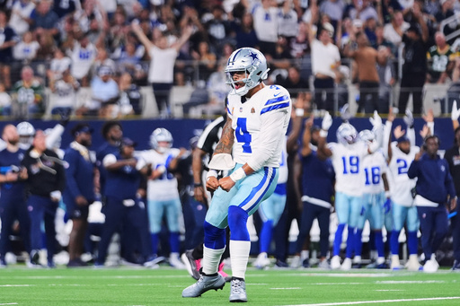 Dallas Cowboys quarterback Dak Prescott celebrates after throwing a touchdown pass to Jake Ferguson in the second half of an NFL football game against the Green Bay Packers Sunday, Sept. 28, 2025, in Arlington, Texas. (AP Photo/Julio Cortez)