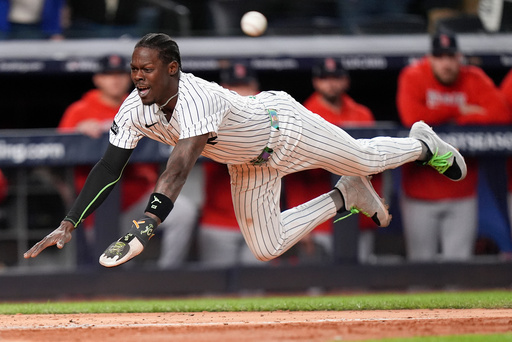 New York Yankees Jazz Chisholm Jr. dives into home plate to score on a hit by Austin Wells against the Boston Red Sox during the eighth inning of Game 2 of an American League wild-card baseball playoff series, Wednesday, Oct. 1, 2025, in New York. (AP Photo/Frank Franklin II)