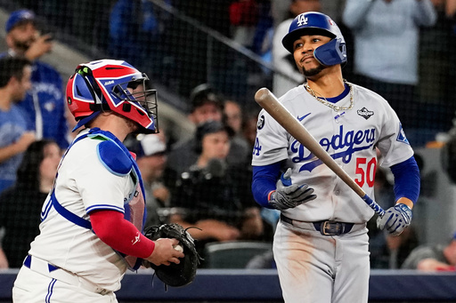Los Angeles Dodgers' Mookie Betts reacts after striking out against the Toronto Blue Jays to end Game 1 of baseball's World Series, Friday, Oct. 24, 2025, in Toronto. (AP Photo/David J. Phillip)