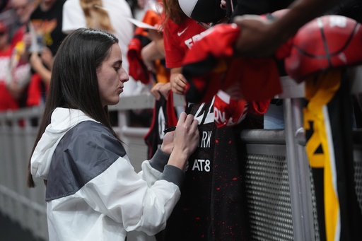 Indiana Fever's Caitlin Clark signs autographs before Game 3 of a WNBA basketball playoff semifinals series against the Las Vegas Aces, Friday, Sept. 26, 2025, in Indianapolis. (AP Photo/Darron Cummings)