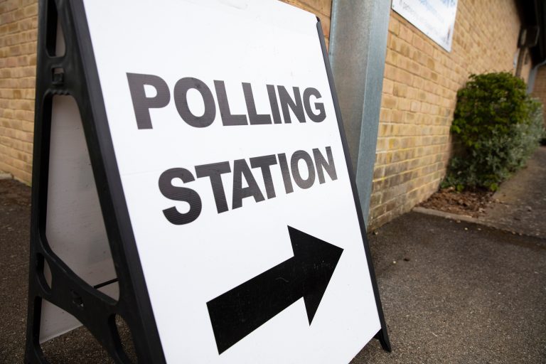Polling station sign outside the entrance to a political voting location in UK.