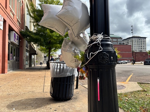 Star-shaped balloons and flowers were tied to street lights in downtown Montgomery, Ala., on Oct. 6, 2025 at the site of a mass shooting that killed two people and wounded a dozen others. (Kim Chandler/Associated Press)