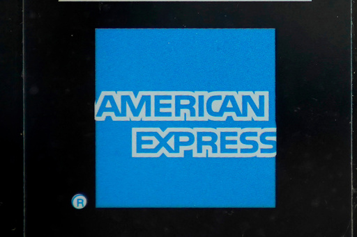 FILE - An American Express logo is attached to a door in Boston's Seaport District, July 21, 2021. (AP Photo/Steven Senne, File)