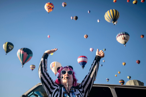 FILE - Launch Director Kat Brennan signals for a pilot to go ahead and take off Oct. 7, 2023, during the Albuquerque International Balloon Fiesta in Albuquerque, N.M. (AP Photo/Roberto E. Rosales, File)