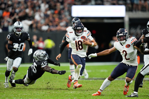 Chicago Bears quarterback Caleb Williams (18) carries the ball past Las Vegas Raiders linebacker Devin White (45) during the second half of an NFL football game Sunday, Sept. 28, 2025, in Las Vegas. (AP Photo/John Locher)