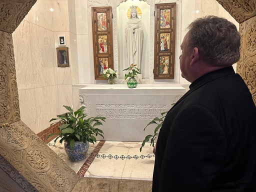 The Rev. John Bettin, rector of the National Shrine of The Little Flower Basilica, looks at a relic of St. Thérèse of Lisieux inside the basilica Tuesday, Sept. 30, 2025, in Royal Oak, Mich. (AP Photo/Mike Householder)