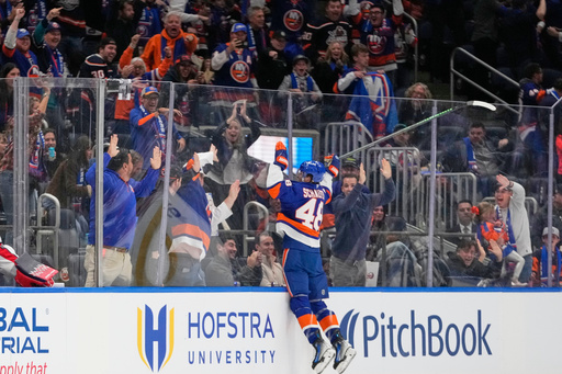 New York Islanders' Matthew Schaefer (48) celebrates after scoring his first NHL goal during the third period of an NHL hockey game against the Washington Capitals Saturday, Oct. 11, 2025, in Elmont, N.Y. (AP Photo/Frank Franklin II)