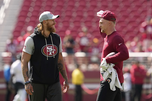 San Francisco 49ers tight end George Kittle, left, and Arizona Cardinals tight end Trey McBride chat prior to an NFL football game Sunday, Sept. 21, 2025, in Santa Clara. (AP Photo/Godofredo A. Vásquez)