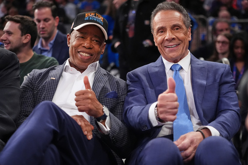 New York City Mayor Eric Adams, left, and Independent candidate former New York Gov. Andrew Cuomo, right, pose during the second half of an NBA basketball game between the New York Knicks and the Cleveland Cavaliers Wednesday, Oct. 22, 2025, at Madison Square Garden in New York. (AP Photo/Frank Franklin II)