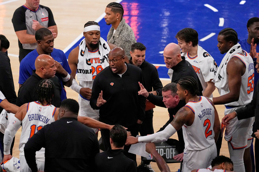 New York Knicks Head Coach Mike Brown, center, talks to his team during the second half of an NBA basketball game against the Cleveland Cavaliers Wednesday, Oct. 22, 2025, at Madison Square Garden in New York. (AP Photo/Frank Franklin II)