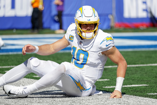 Los Angeles Chargers quarterback Justin Herbert (10) gets up off the turf after throwing an interception against the New York Giants during the first quarter of an NFL football game, Sunday, Sept. 28, 2025, in East Rutherford, N.J. (AP Photo/Adam Hunger)