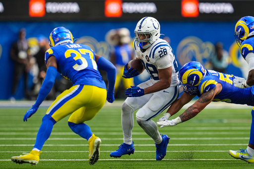 Indianapolis Colts running back Jonathan Taylor (28) is tackled by Los Angeles Rams linebacker Nate Landman (53) and safety Quentin Lake (37) during the second hall of an NFL football game Sunday, Sept. 28, 2025, in Inglewood, Calif. (AP Photo/Marcio Jose Sanchez)