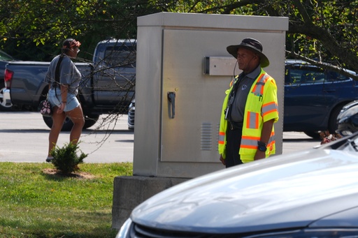 School crossing guard Anthony Taylor operates a traffic control box, Wednesday, Sept. 3, 2025, in Indianapolis. (AP Photo/Darron Cummings)