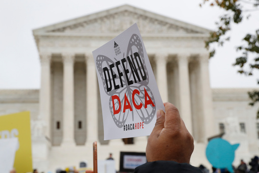 FILE - People rally outside the Supreme Court in support of the Deferred Action for Childhood Arrivals program (DACA), in Washington, Nov. 12, 2019. (AP Photo/Jacquelyn Martin, File)