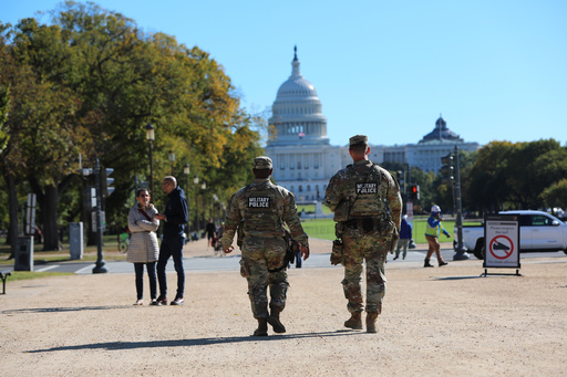 National Guard soldiers patrol on the National Mall near the U.S. Capitol, Friday, Oct. 17, 2025, in Washington. (AP Photo/Rahmat Gul)