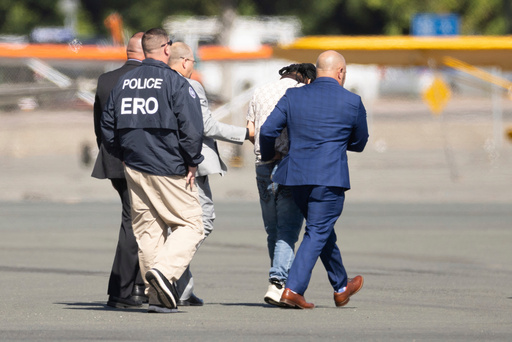 FILE - Harjinder Singh is escorted to an airplane by Florida Lt. Gov. Jay Collins and law enforcement, Aug. 21, 2025, in Stockton, Calif. (AP Photo/Benjamin Fanjoy, File)