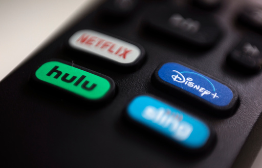 FILE - The logos for streaming services Netflix, Hulu, Disney Plus and Sling TV are pictured on a remote control on Aug. 13, 2020, in Portland, Ore. (AP Photo/Jenny Kane, File)
