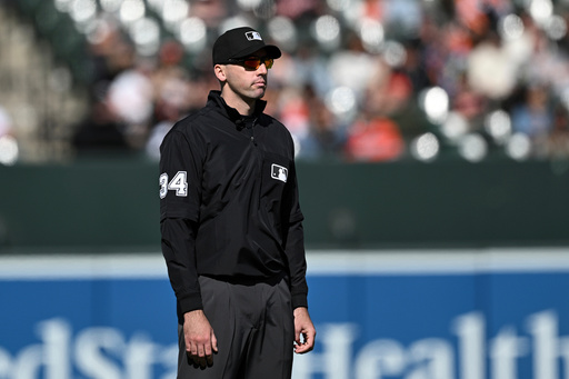 FILE - Umpire Nate Tomlinson looks on during a baseball game between the Baltimore Orioles and the Toronto Blue Jays in Baltimore, April 13, 2025. (AP Photo/Terrance Williams, File)