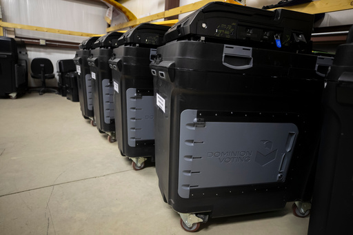 FILE - Dominion Voting ballot counting machines are lined up at a Torrance County warehouse during a testing of election equipment in Estancia, N.M., Sept. 29, 2022.(AP Photo/Andres Leighton, File)