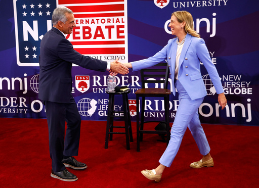 FILE - Republican candidate Jack Ciattarelli, left, shake hands with Democratic candidate for governor Mikie Sherrill, right, before a gubernatorial debate Sept. 21, 2025, in Lawrenceville, N.J. (AP Photo/Noah K. Murray, File)