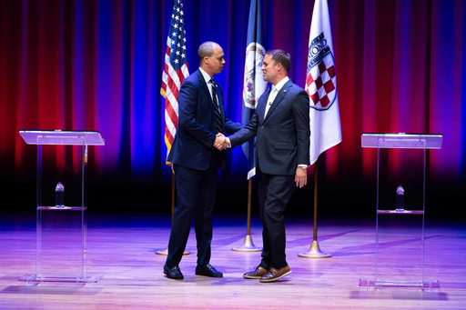 Democrat Jay Jones, left, and Republican incumbent Jason Miyares shake hands at the start of the Virginia attorney general debate in Richmond, Va., Thursday, Oct. 16, 2025. (Mike Kropf/Richmond Times-Dispatch via AP, Pool)