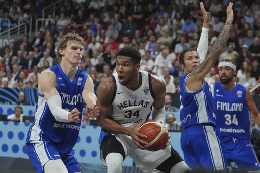Finland's Lauri Markkanen, left, and Greece's Giannis Antetokounmpo in action during the Eurobasket, European Basketball Championship third place match between Greece and Finland at the Riga Arena in Riga, Latvia, Sunday, Sept. 14, 2025. (AP Photo/Sergei Grits)