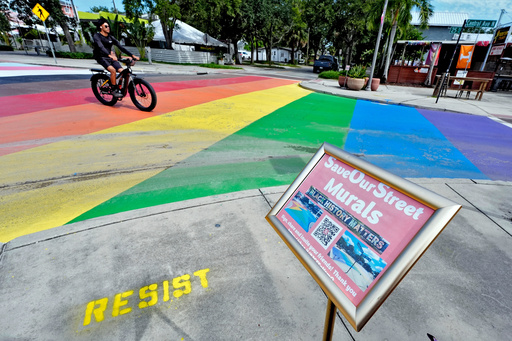 FILE - A cyclist crosses a rainbow-painted intersection, Aug. 27, 2025, in St. Petersburg, Fla. (AP Photo/Chris O'Meara, file)