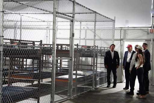 FILE - President Donald Trump, Gov. Ron DeSantis, R-Fla., and Homeland Security Secretary Kristi Noem, and others, tour "Alligator Alcatraz," a new migrant detention facility at Dade-Collier Training and Transition facility, Tuesday, July 1, 2025, in Ochopee, Fla. (AP Photo/Evan Vucci, File)