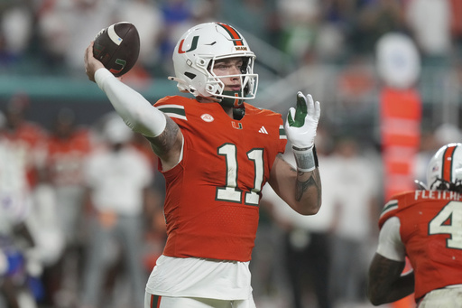 Miami quarterback Carson Beck (11) aims a pass during the second half of an NCAA college football game against Florida, Saturday, Sept. 20, 2025, in Miami Gardens, Fla. (AP Photo/Marta Lavandier)