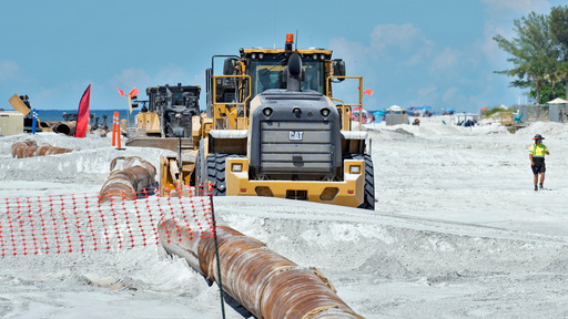 Workers replace the sand washed away by recent hurricanes along the gulf Thursday, Sept. 25, 2025, in Indian Rocks Beach, Fla. (AP Photo/Chris O'Meara)