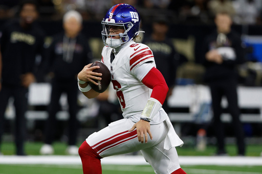 New York Giants quarterback Jaxson Dart (6) runs out of the pocket against the New Orleans Saints in the first half of an NFL football game, Sunday, Oct. 5, 2025, in New Orleans. (AP Photo/Butch Dill)