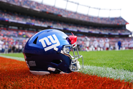 FILE - A New York Giants helmet is shown on the field before an NFL football game between the Denver Broncos and the Giants in Denver on Oct. 19, 2025. (AP Photo/Jack Dempsey, File)