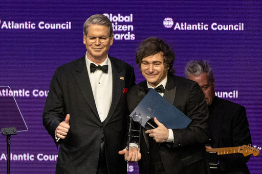 United States Secretary of the Treasury, Scott Bessent presents an award to the President of Argentina Javier Milei at the Global Citizen Awards ceremony, Wednesday, Sept. 24, 2025, in New York. (AP Photo/Stefan Jeremiah)
