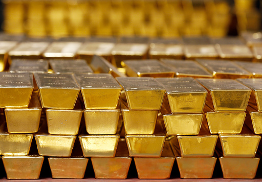 FILE - Gold bars are stacked in a vault at the United States Mint on July 22, 2014, in West Point, N.Y. (AP Photo/Mike Groll, File)