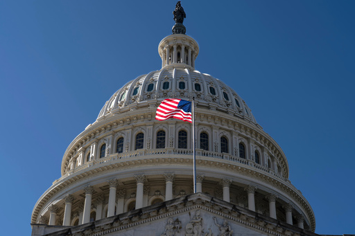 The American flag flies over the Capitol in Washington, on the ninth day of the government shutdown, Thursday, Oct. 9, 2025. (AP Photo/J. Scott Applewhite)