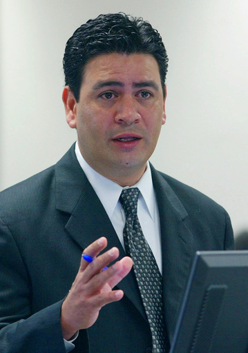 FILE - David Herrera Urias, attorney for plaintiffs, questions a witness during a trial Aug. 26, 2004, in Austin, Texas. (AP Photo/Harry Cabluck, File)
