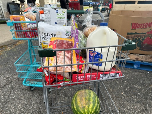 Food and milk sit in a shopping cart during a Forgotten Harvest distribution event held at Woodside Bible Church, Friday, Oct. 24, 2025, in Pontiac, Mich. (AP Photo/Mike Householder)