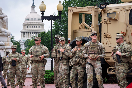 FILE - National Guard troops congregate at the entrance to Union Station in Washington, Aug. 20, 2025. (AP Photo/J. Scott Applewhite, FIle)
