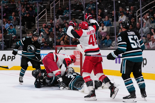 Carolina Hurricanes left wing William Carrier (28) scores a goal against San Jose Sharks goaltender Alex Nedeljkovic (33) during the second period of an NHL hockey game, Tuesday, Oct. 14, 2025, in San Jose, Calif. (AP Photo/Godofredo A. Vásquez)