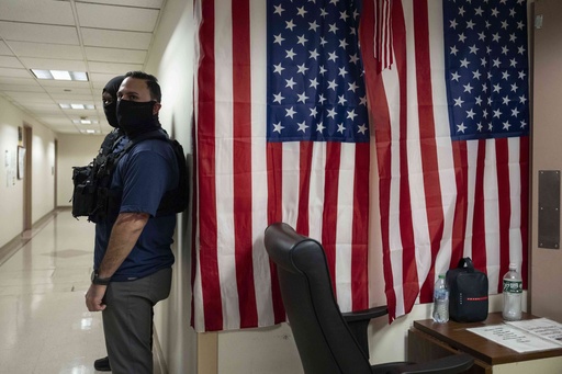Federal agents stand outside an immigration court at the Jacob K. Javits federal building in New York, Wednesday, Sept. 17, 2025. (AP Photo/Yuki Iwamura)