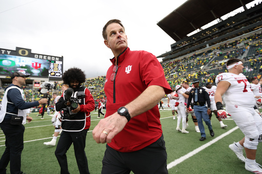 Indiana head coach Curt Cignetti, center, walks on the field after a win over Oregon in an NCAA college football game, Saturday, Oct. 11, 2025, in Eugene, Ore. (AP Photo/Lydia Ely)