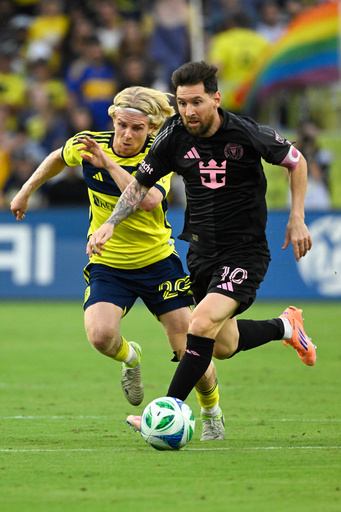 Inter Miami forward Lionel Messi (10) dribbles up the field as Nashville SC midfielder Edvard Tagseth (20) defends during the first half of a MLS soccer match Saturday, Oct. 28, 2025, in Nashville, Tenn. (AP Photo/John Amis)