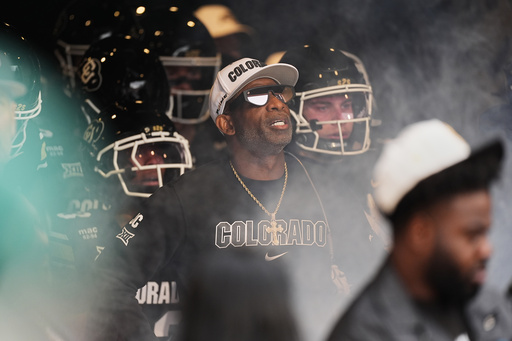 Colorado head coach Deion Sanders waits to take the field with players ahead of an NCAA college football game against Iowa State, Saturday, Oct. 11, 2025, in Boulder, Colo. (AP Photo/David Zalubowski)