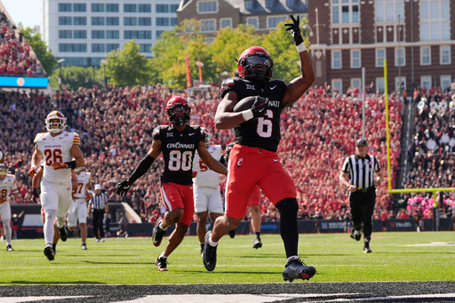 Cincinnati running back Evan Pryor (6) celebrates as he scores a touchdown against Iowa State during the first half of an NCAA football game, Saturday, Oct. 4, 2025, in Cincinnati. (AP Photo/Carolyn Kaster)