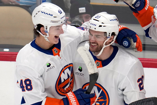 New York Islanders' Jonathan Drouin (29) celebrates after his goal with Matthew Schaefer (48) during the first period of an NHL hockey game against the Pittsburgh Penguins in Pittsburgh, Thursday, Oct. 9, 2025. (AP Photo/Gene J. Puskar)